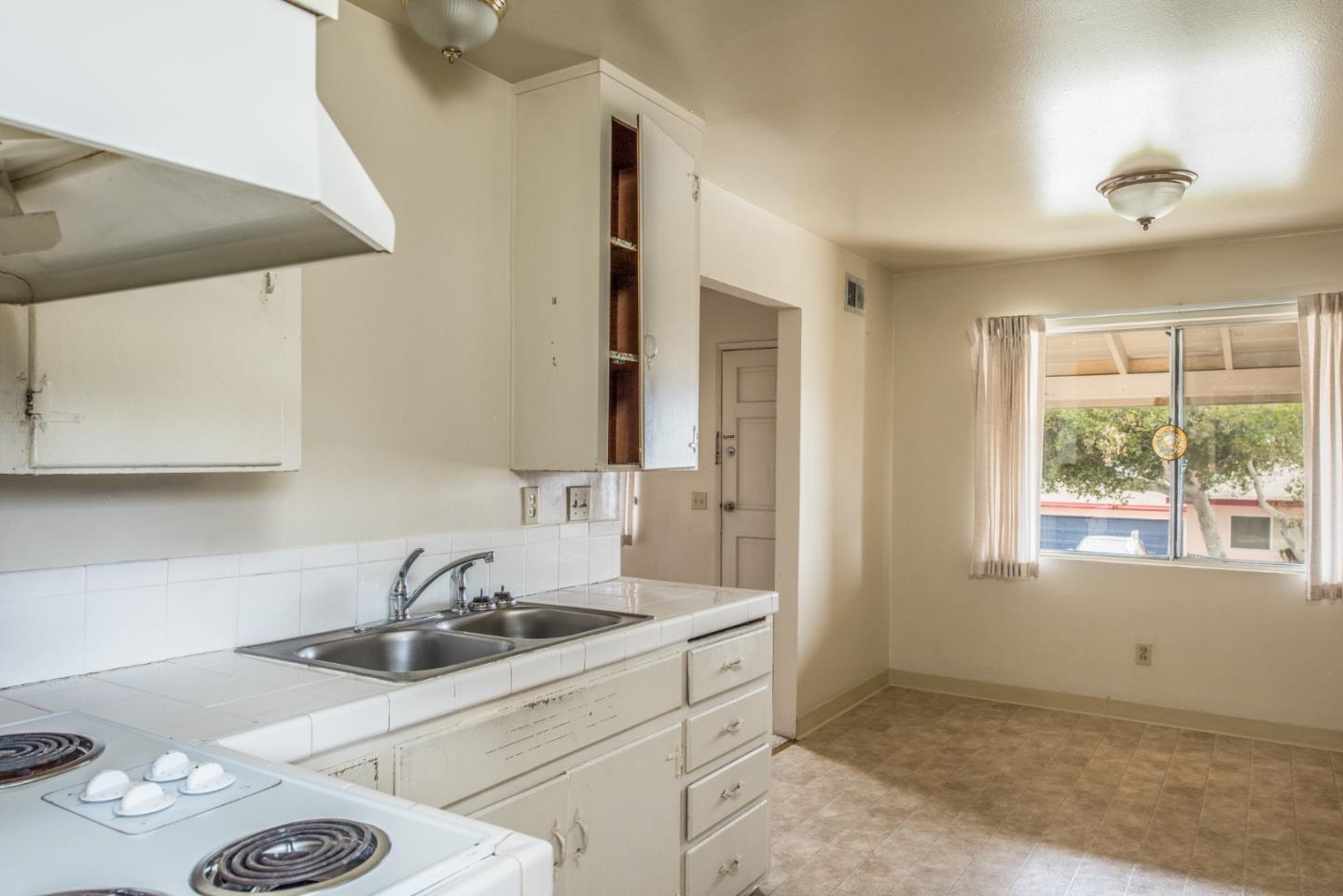 1816 Juarez Street Seaside, CA 93955 - Photo 12 of 27 a kitchen with sink a stove and cabinets