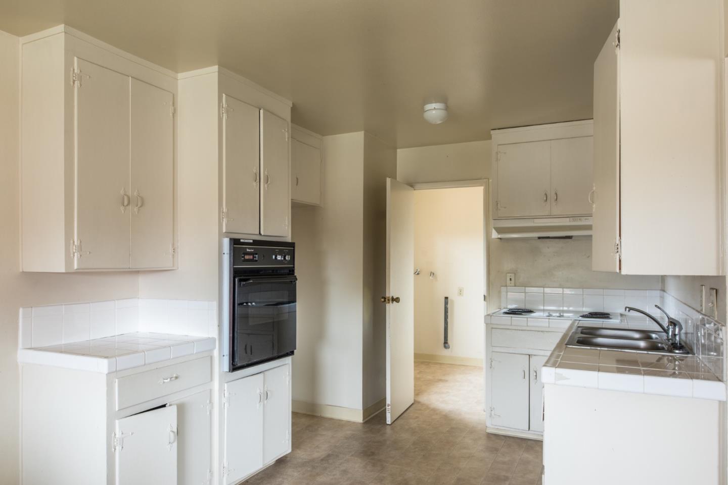 1816 Juarez Street Seaside, CA 93955 - Photo 9 of 27 a kitchen with a sink a stove and refrigerator