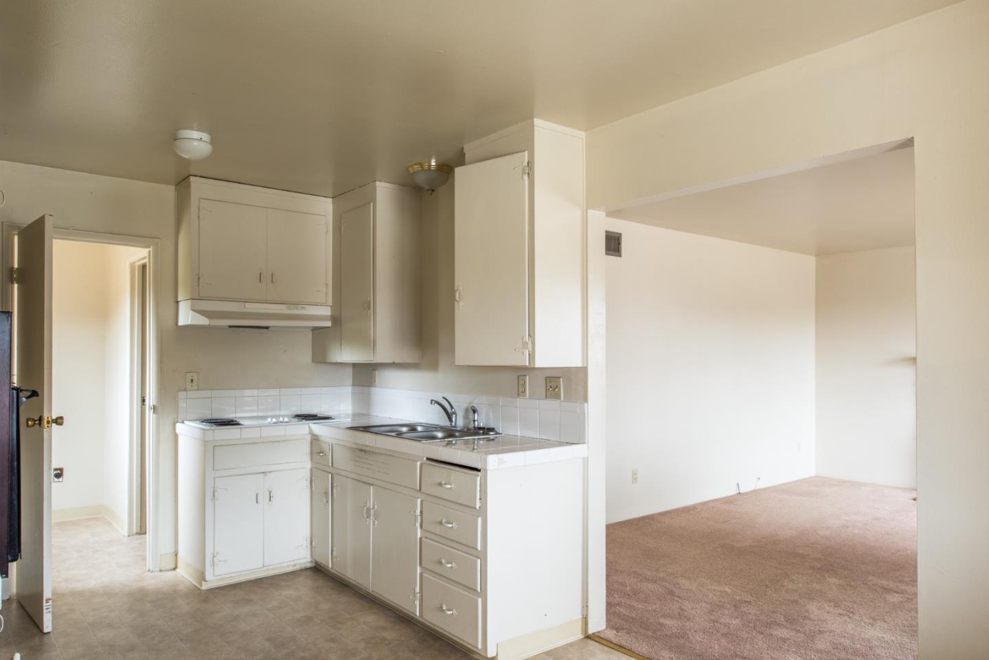 1816 Juarez Street Seaside, CA 93955 - Photo 10 of 27 a kitchen with white cabinets and white appliances