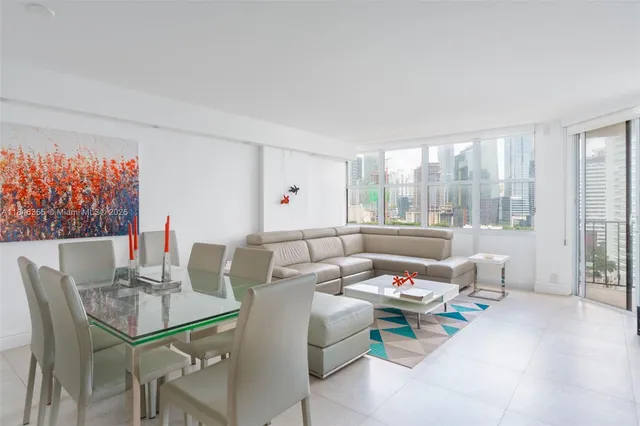 a living room with furniture and a floor to ceiling window