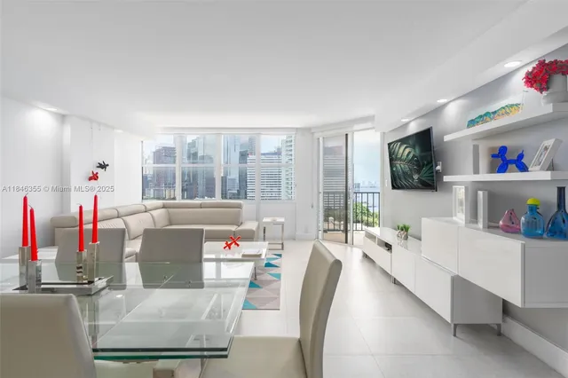 a living room with furniture and a floor to ceiling window