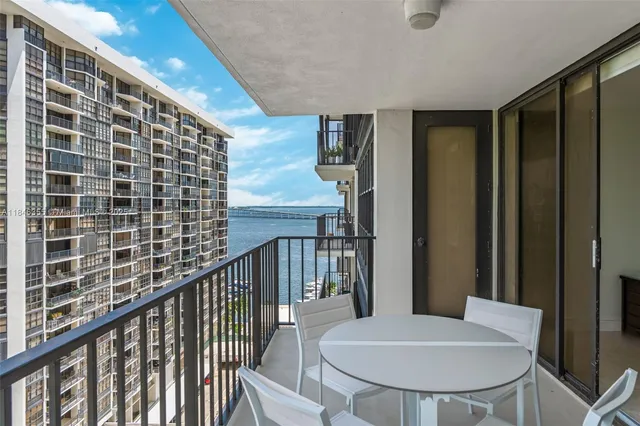 a view of a balcony with table and chairs