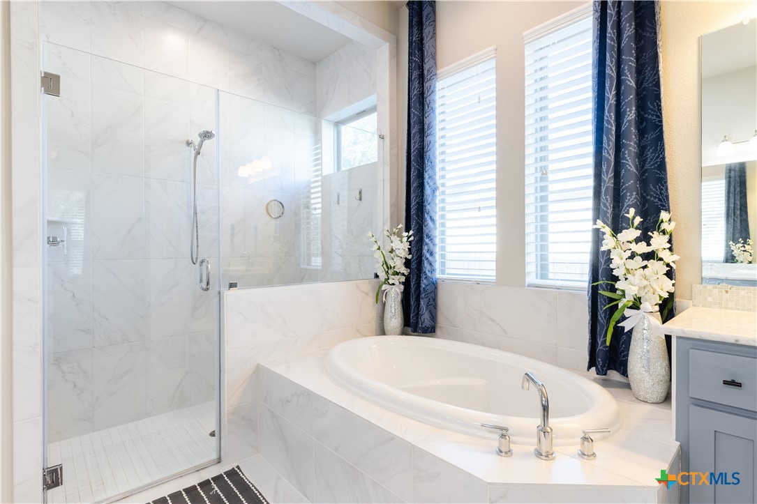 264 Axis Loop Georgetown, TX 78628 - Photo 20 of 33 a white bath tub sitting in a bathroom next to a window
