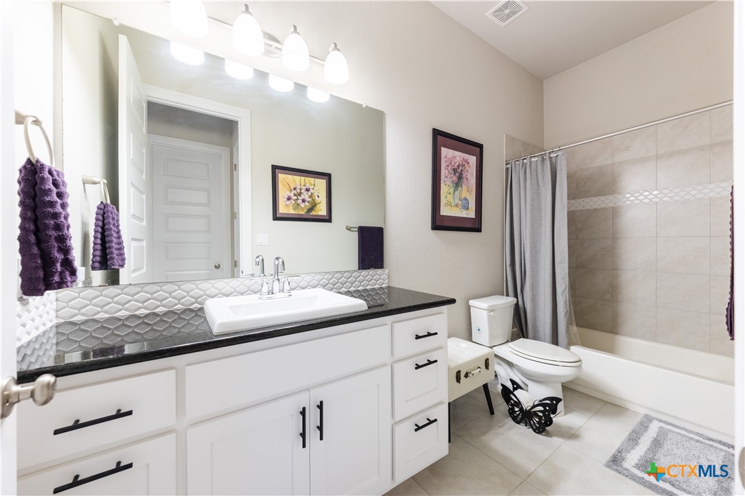 264 Axis Loop Georgetown, TX 78628 - Photo 22 of 33 a bathroom with a sink a toilet and a mirror