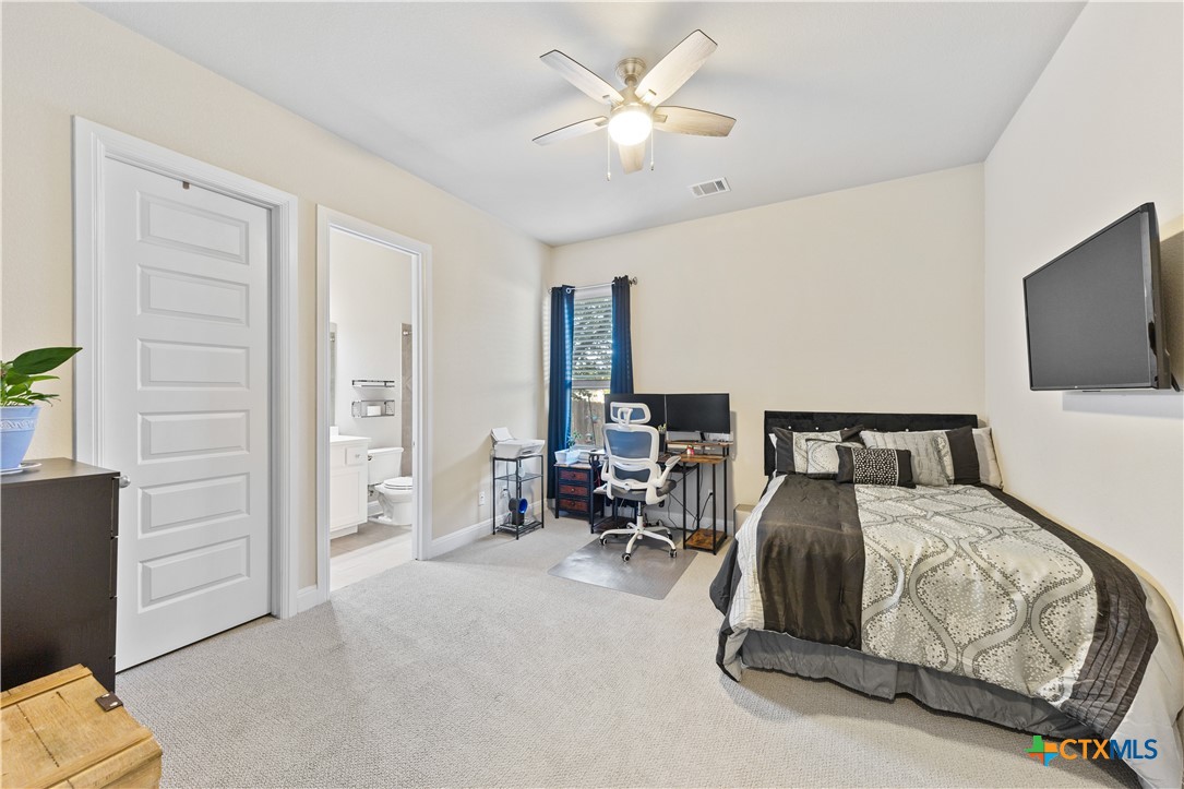 264 Axis Loop Georgetown, TX 78628 - Photo 24 of 33 a bedroom with furniture and a flat screen tv