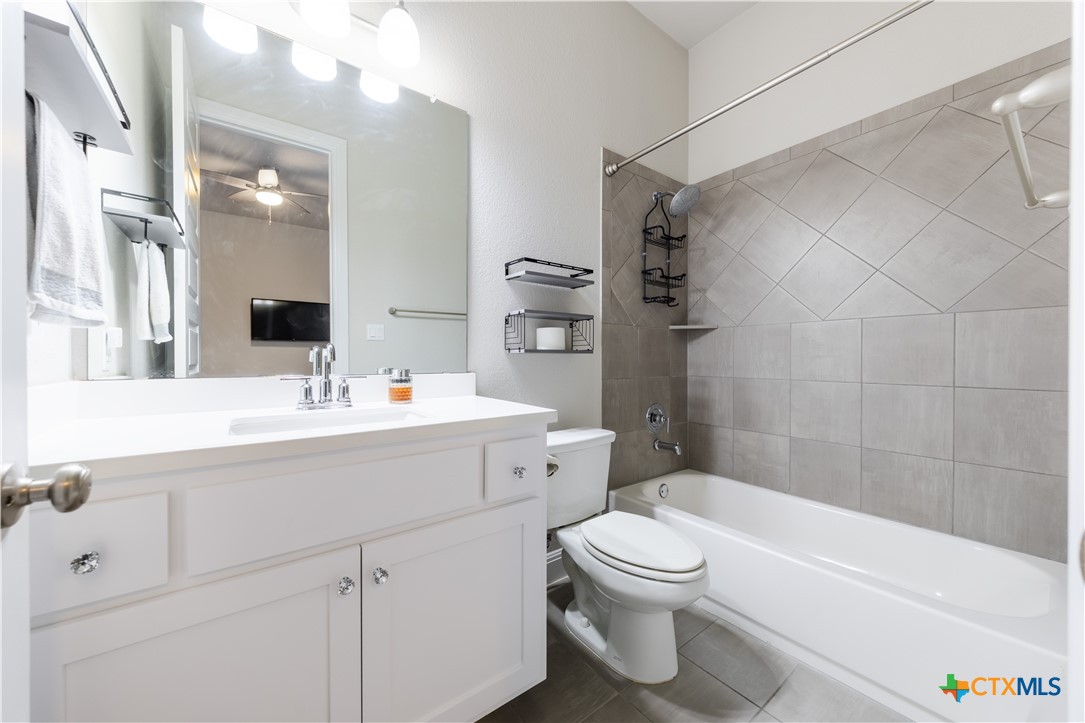 264 Axis Loop Georgetown, TX 78628 - Photo 25 of 33 a bathroom with a sink a toilet and shower