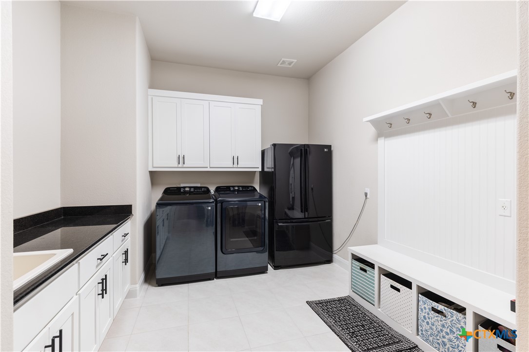 264 Axis Loop Georgetown, TX 78628 - Photo 26 of 33 a kitchen with a refrigerator and a sink
