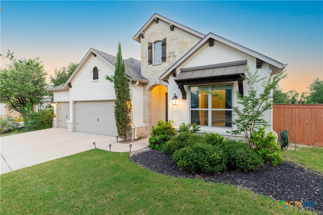 264 Axis Loop Georgetown, TX 78628 - Photo 4 of 33 a front view of house with a garden