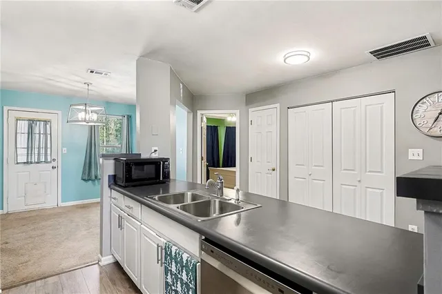 a kitchen with stainless steel appliances a sink and a refrigerator