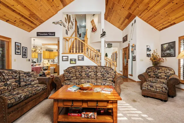 a living room with furniture a couch and dresser with wooden floor