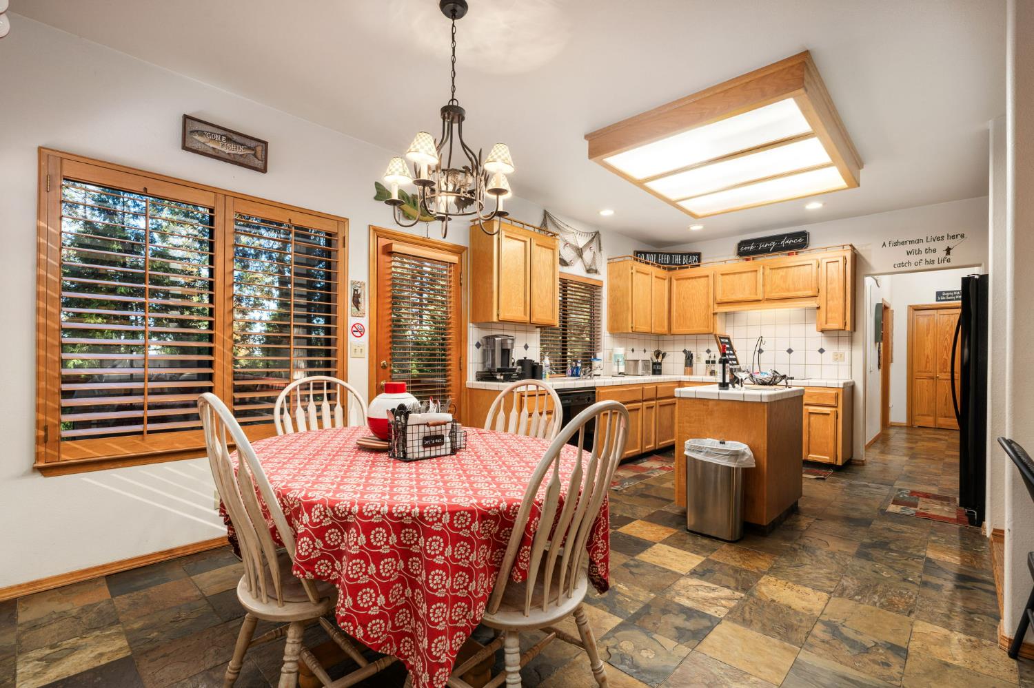 41811 Gray Rock Road Shaver Lake, CA 93664 - Photo 14 of 33 a dining room with furniture a chandelier and window