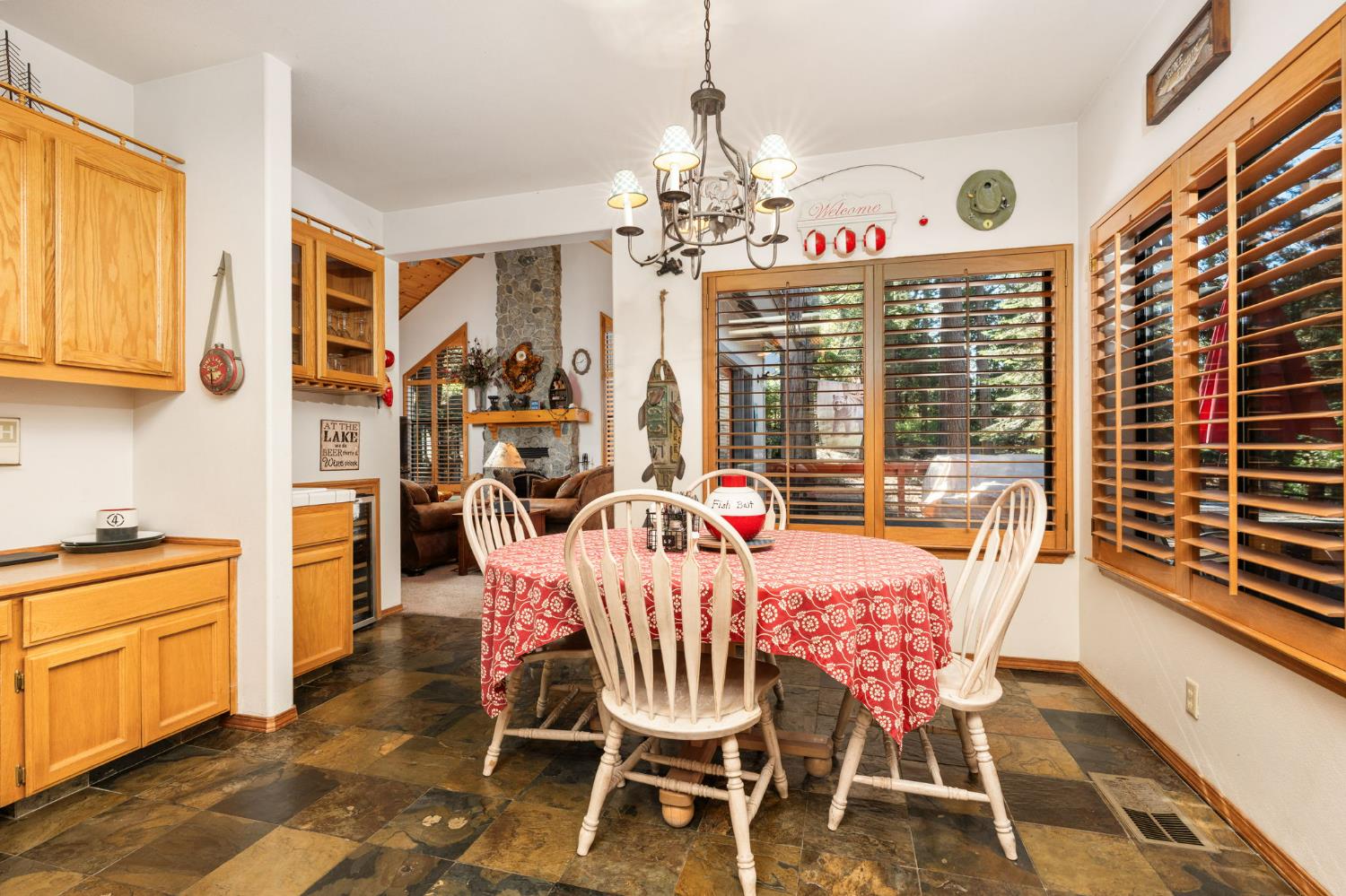 41811 Gray Rock Road Shaver Lake, CA 93664 - Photo 15 of 33 a dining room with furniture a chandelier and wooden floor