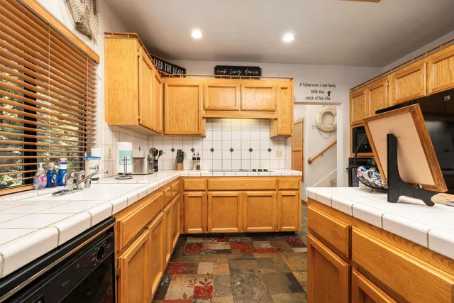 a kitchen with stainless steel appliances kitchen island granite countertop a sink and cabinets