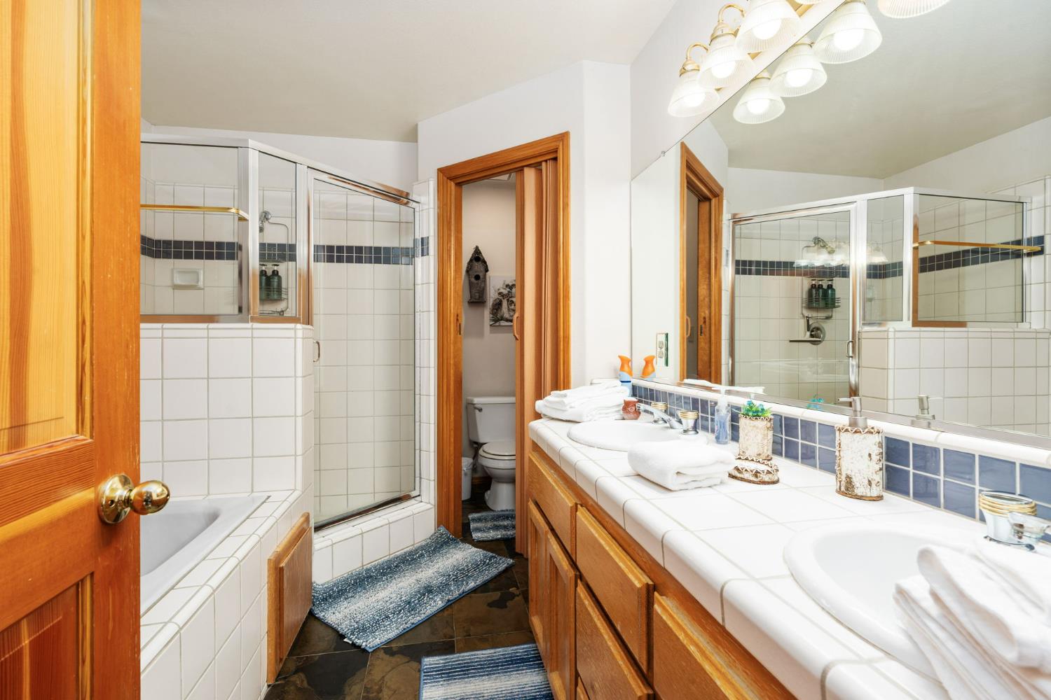 41811 Gray Rock Road Shaver Lake, CA 93664 - Photo 28 of 33 a bathroom with a tub sink and mirror