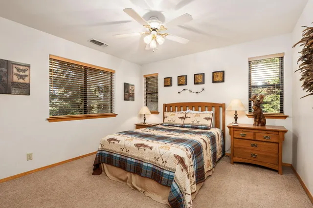 a bathroom with a double vanity sink toilet mirror and tub