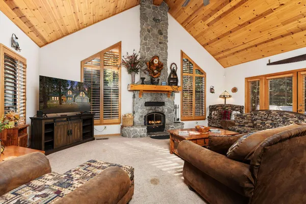 a living room with furniture a fireplace and a flat screen tv