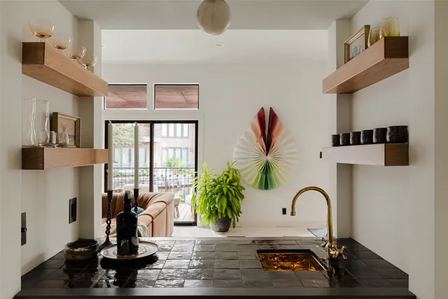 a table with a potted plant on a counter and a wooden floor
