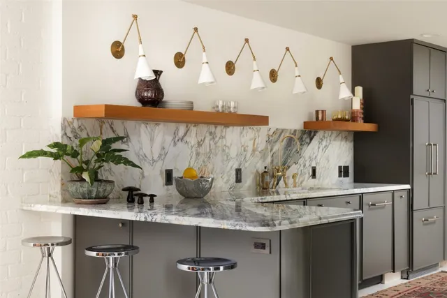 a kitchen with stainless steel appliances granite countertop a sink and white cabinets