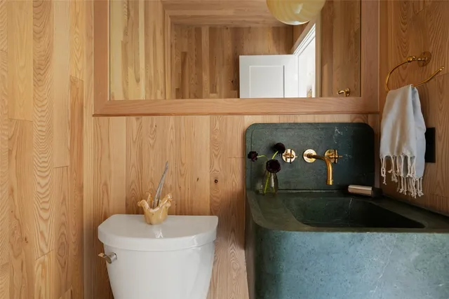 a bathroom with a sink a toilet and a mirror