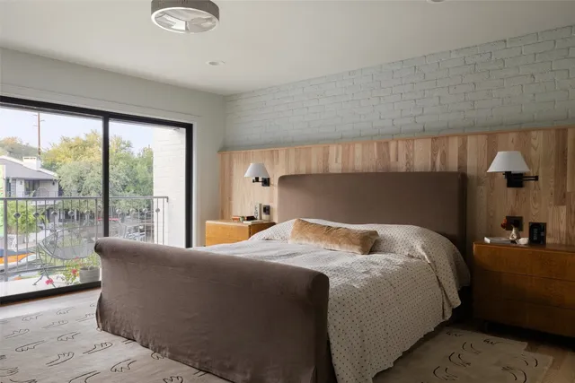 a bedroom with a large bed and a large window