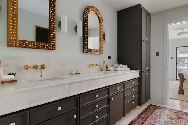 a spacious bathroom with double vanity sinks and a mirror