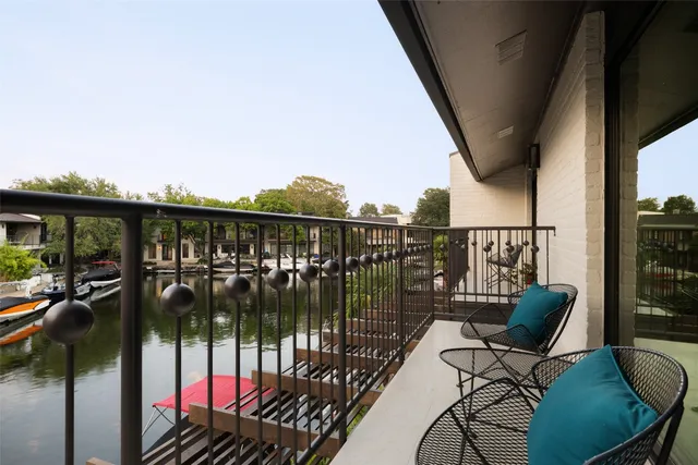 a view of a balcony with chairs and wooden floor