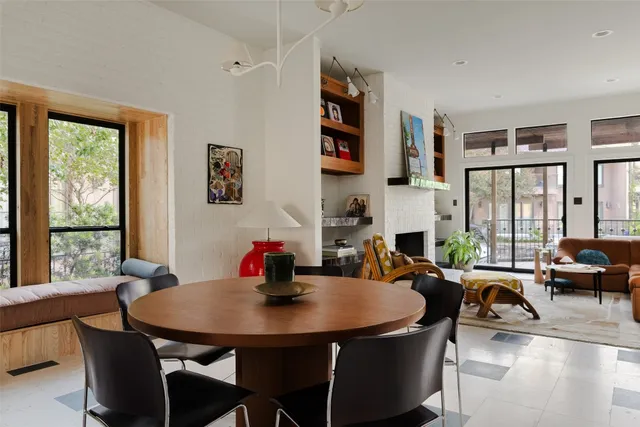 a view of a dining room with furniture large windows and wooden floor