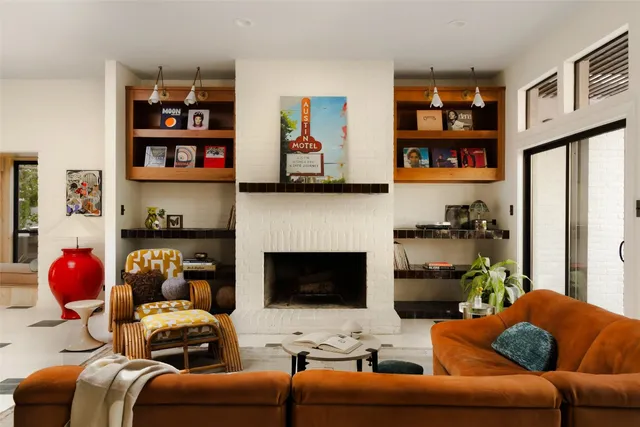 a living room with furniture cabinets and a window