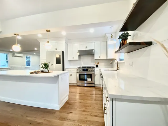 a large kitchen with stainless steel appliances