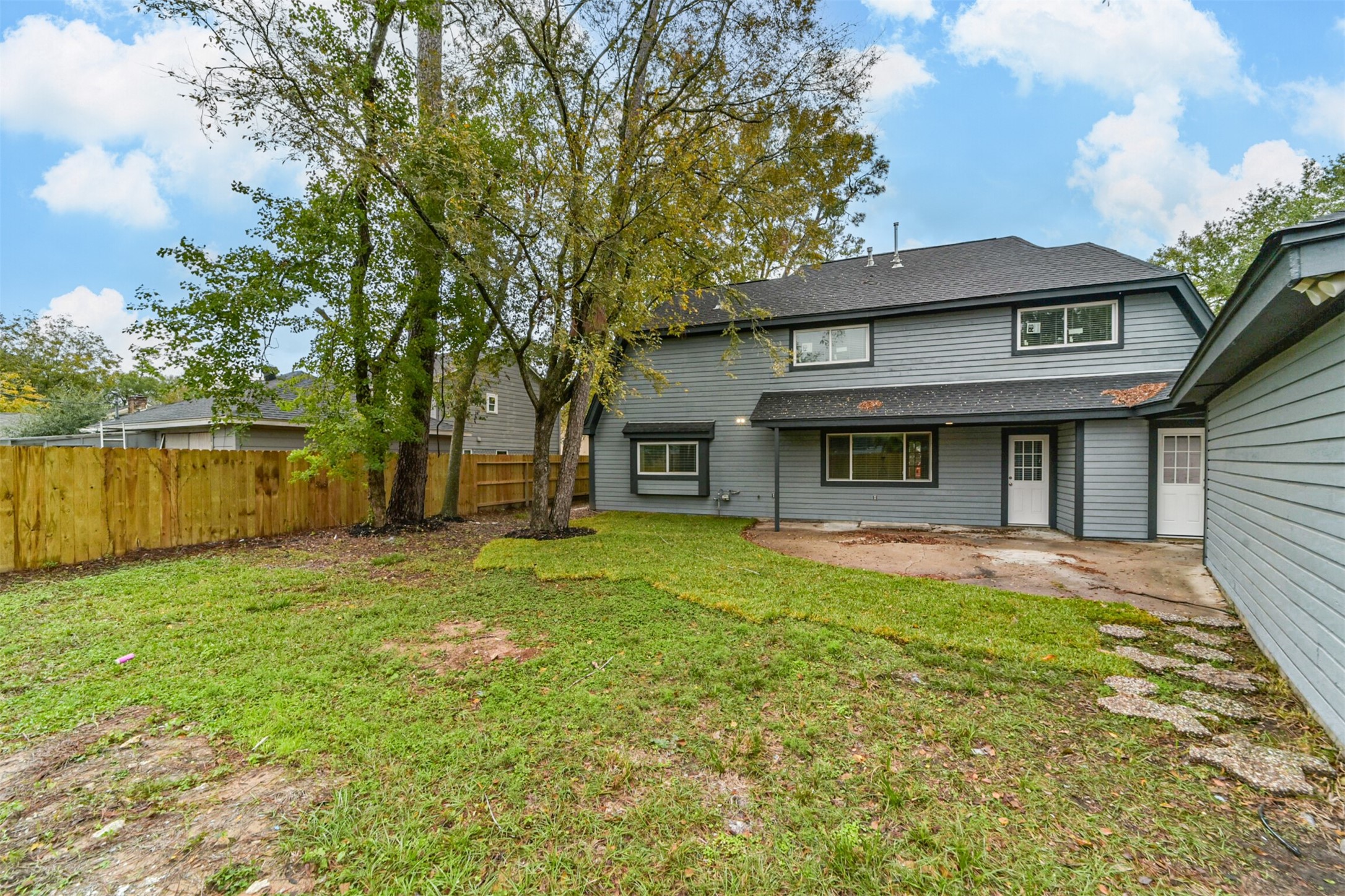 15610 Ripplewind Lane Houston, TX 77068 - Photo 42 of 44 a view of a house with a yard and large trees