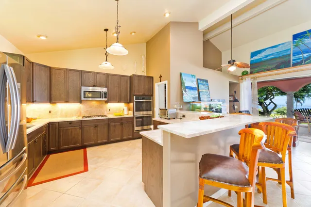 a large kitchen with kitchen island a large counter space dining table and chairs