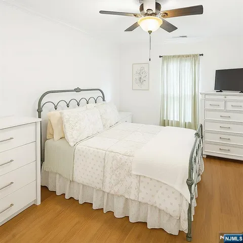 a view of walk in closet with wooden floor