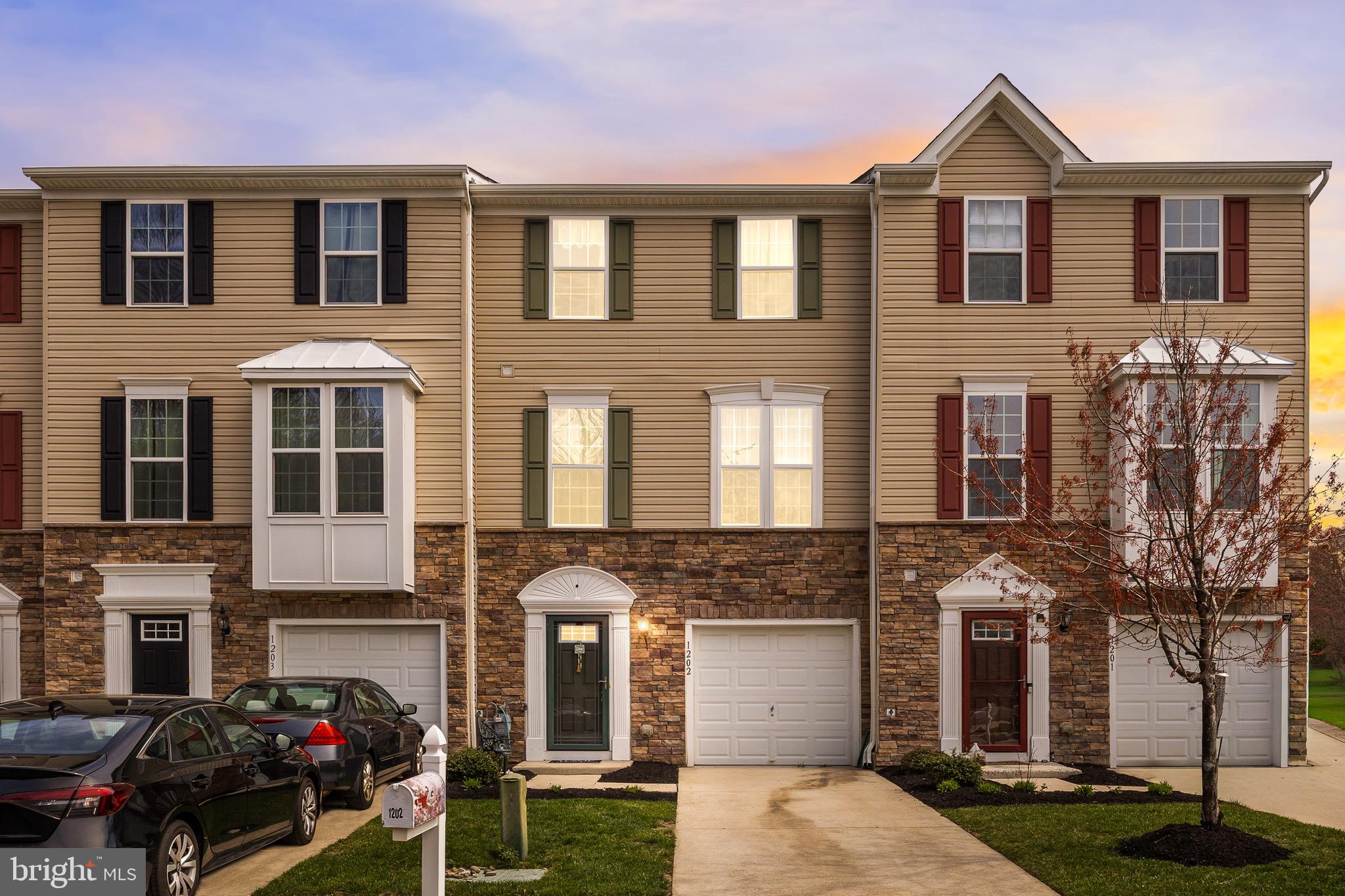 a front view of a residential apartment building with a yard