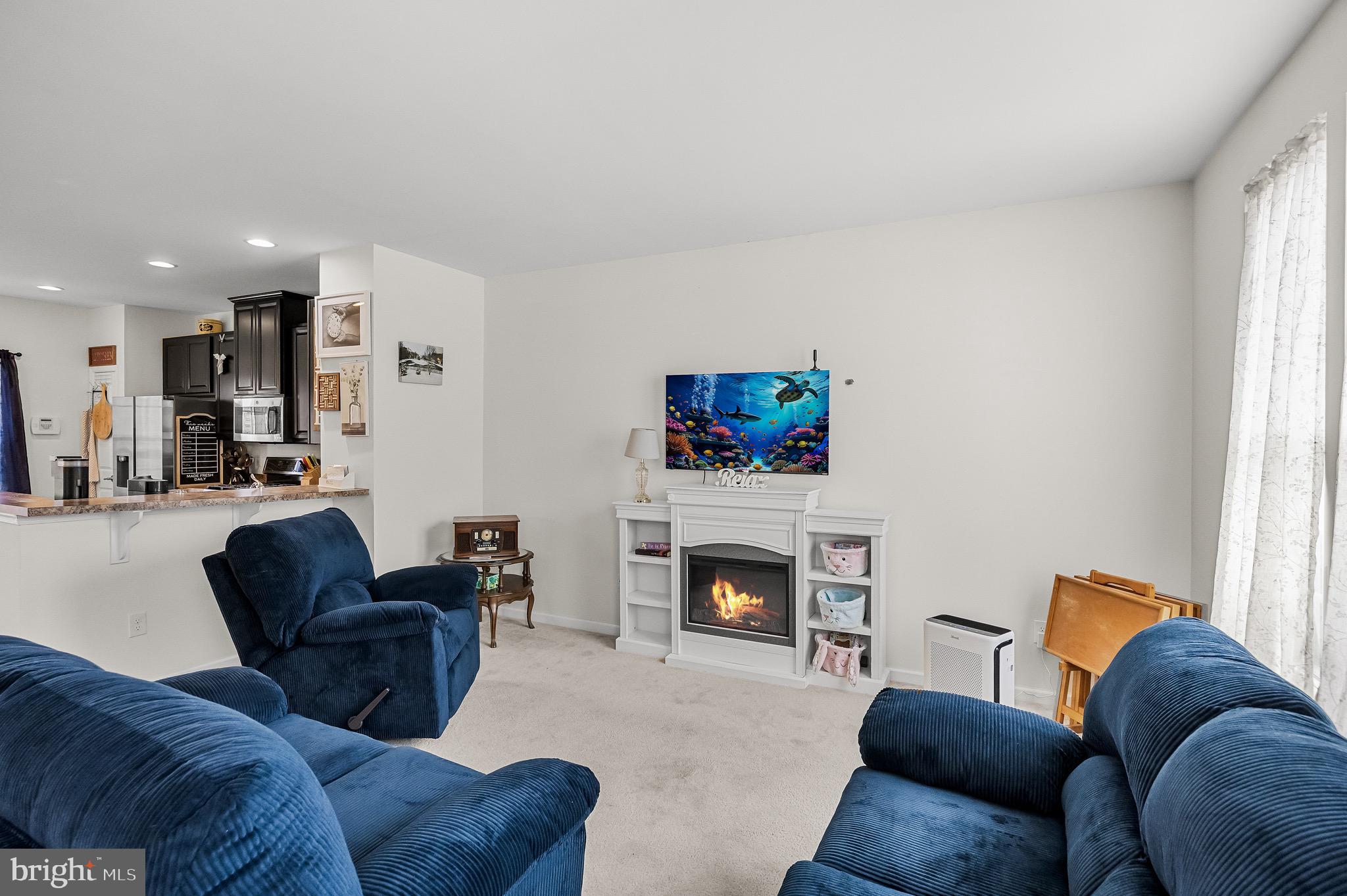 1202 Emerson Court Clementon, NJ 08021 - Photo 11 of 36 a living room with furniture and a fireplace
