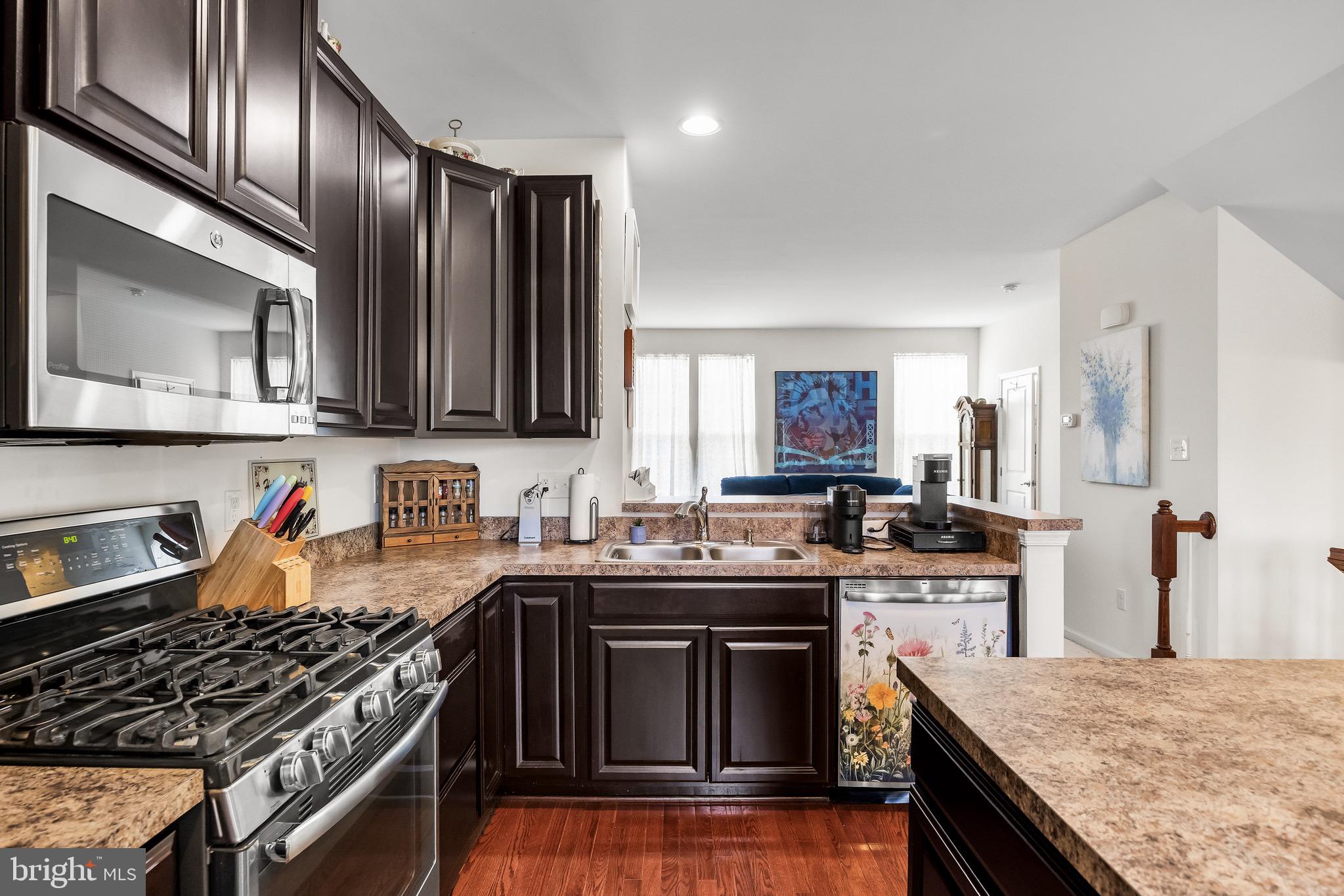 1202 Emerson Court Clementon, NJ 08021 - Photo 18 of 36 a kitchen with stainless steel appliances granite countertop a stove sink and cabinets