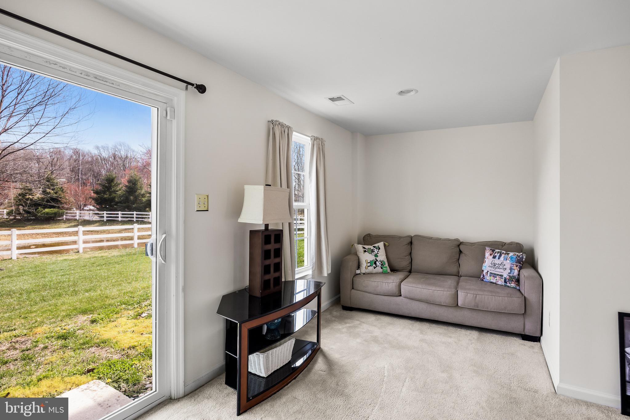 1202 Emerson Court Clementon, NJ 08021 - Photo 26 of 36 a living room with furniture and a floor to ceiling window