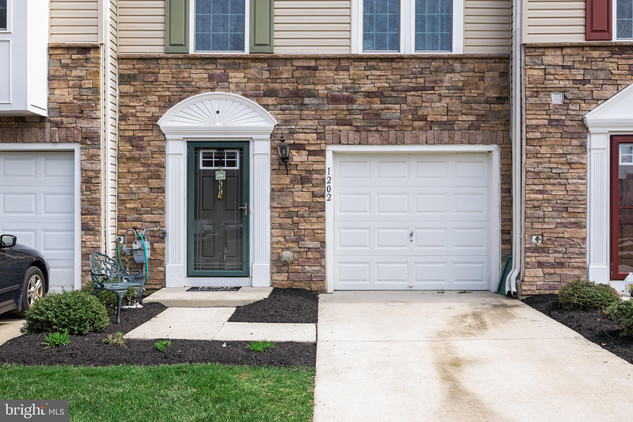 1202 Emerson Court Clementon, NJ 08021 - Photo 7 of 36 a view of a brick house with a sink and a yard
