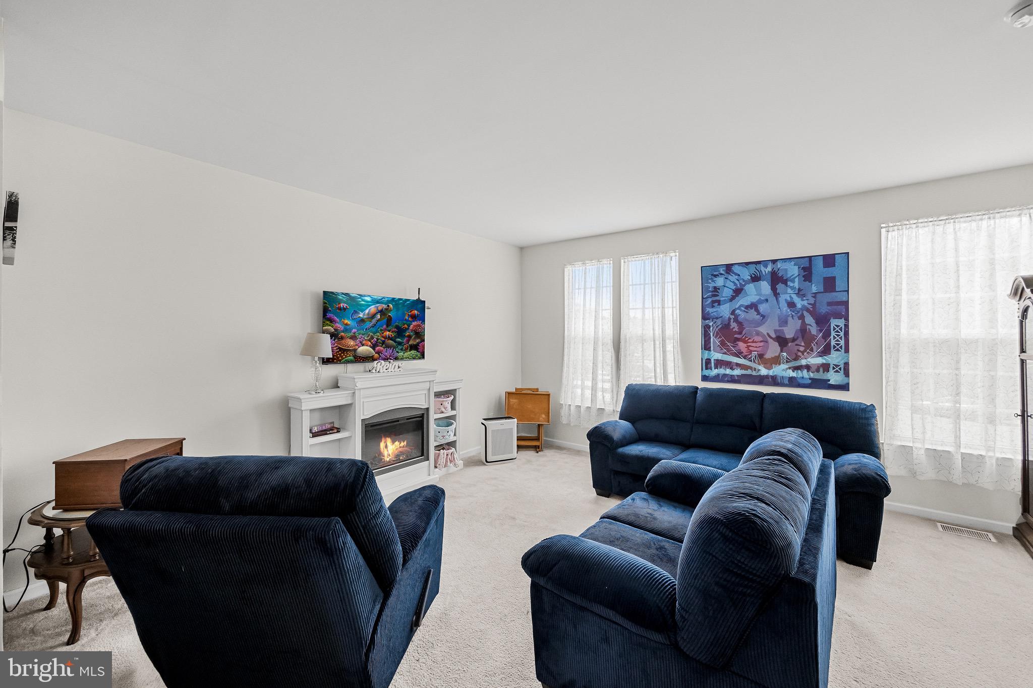 1202 Emerson Court Clementon, NJ 08021 - Photo 10 of 36 a living room with furniture a fireplace and a flat screen tv