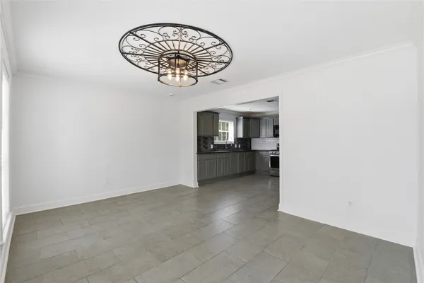 an empty room with a kitchen
