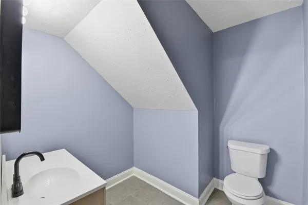 a white toilet sitting next to a bathroom sink