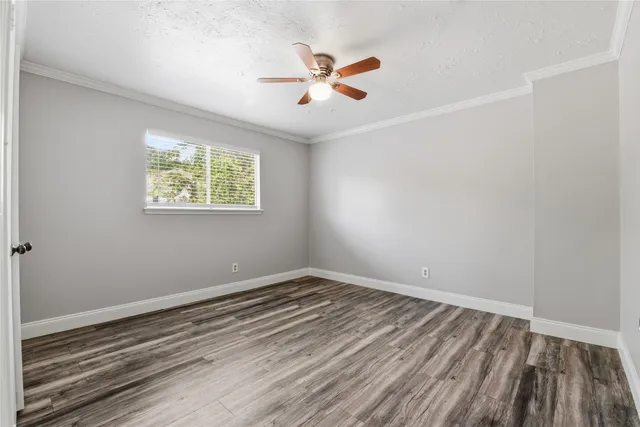 a view of a room with wooden floor