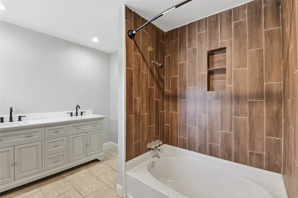 a bathroom with a tub and shower