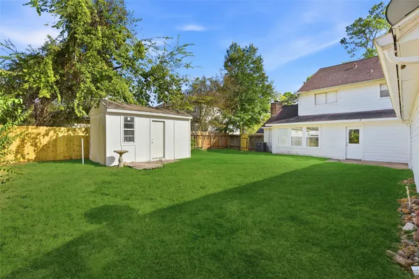 a front view of a house with a garden and yard