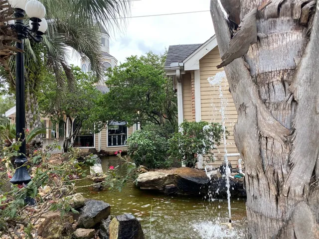 a view of a house with a yard and sitting area