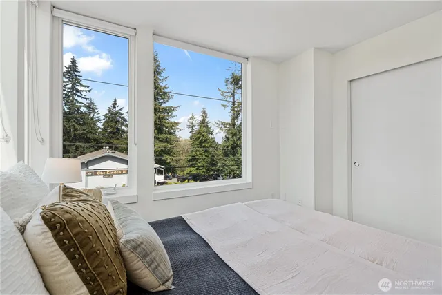 a bedroom with a large bed and a window