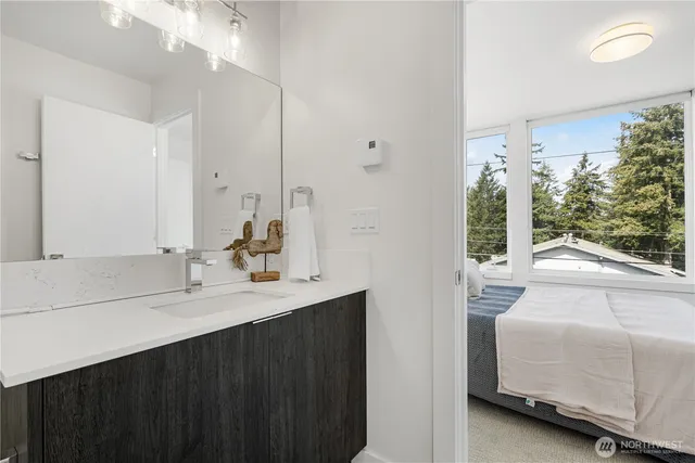 a en suite bathroom with a sink and mirror