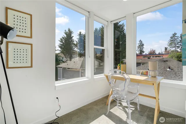 a dining room with furniture and a window