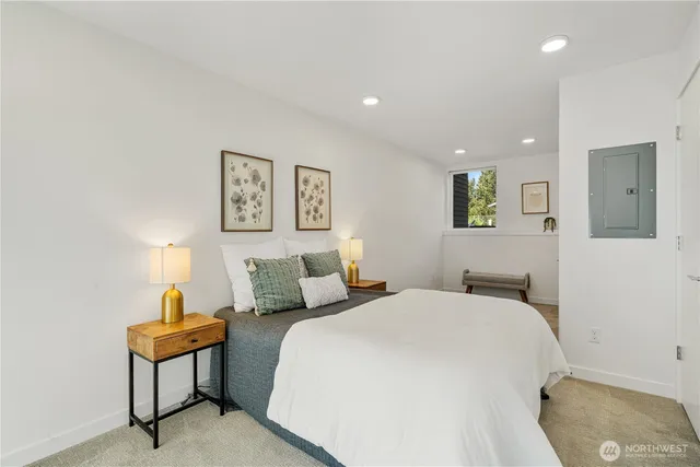 a bedroom with a bed and painting on the wall