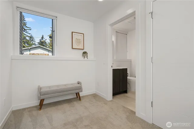 a view of a livingroom with an entryway and a workspace