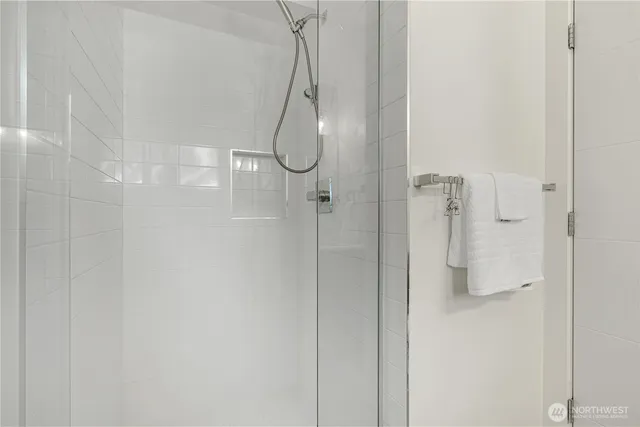 a bathroom with a glass shower door